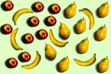 Fototapeta na wymiar Fruit pattern. Repeating of whole bananas, red apples, and yellow pears on a light green background. Interesting fruit pattern made from natural fruits. Horizontal. The concept of healthy food 