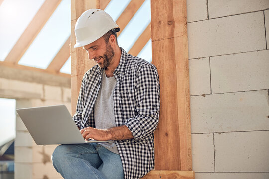 Ambitious Field Engineer Working On His Laptop Near A Building