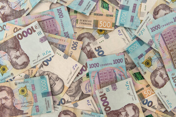 Fototapeta na wymiar seamless texture of real new ukraine 500 and 1000 banknotes. Pile of hryvnia as financial background.