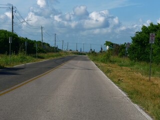 One of the roads in Galveston, Texas, with thick clouds in the skies.