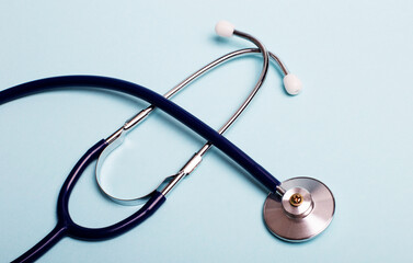 On a blue background, a stethoscope close-up. Medical concept