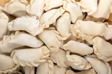 homemade raw dumpling with potatoes as grocery background