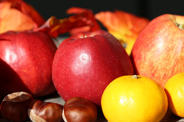 Fototapeta na wymiar Apples and mandarins on a rustic wooden table as autumnal motif
