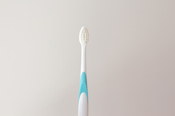 White plastic toothbrush. Soft bristles for healthy gums and tooth enamel. Copy space for your design