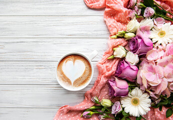 Pink flowers and cup of coffee