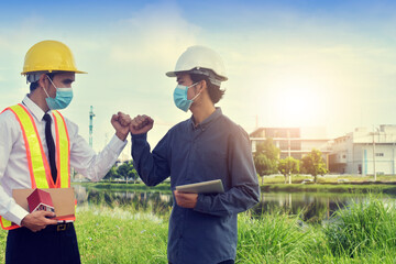 Engineers saluting each other by no touching protect coronavirus covid 19, Two business people shake hand no touch outdoor on site construction