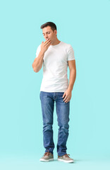 Exhausted man on color background. Diabetes symptoms