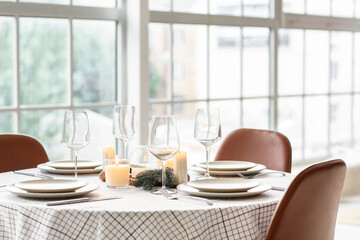 Beautiful table setting with Christmas decorations in living room