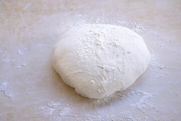 pizza dough on a pastry board