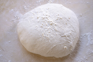 pizza dough on a pastry board