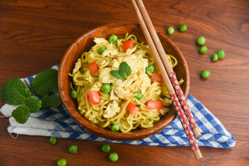 Vegetarian Schezwan Noodles Vegetable Hakka Noodles or Chow Mein in wooden bowl Schezwan Noodles is indo-chinese cuisine hot dish udon noodles Indonesian fried egg noodle. Indian Instant noodles ramen