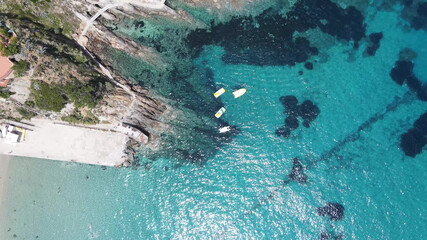 Colourful Pedal Boat on the shoreline. Overhead aerial view from drone.