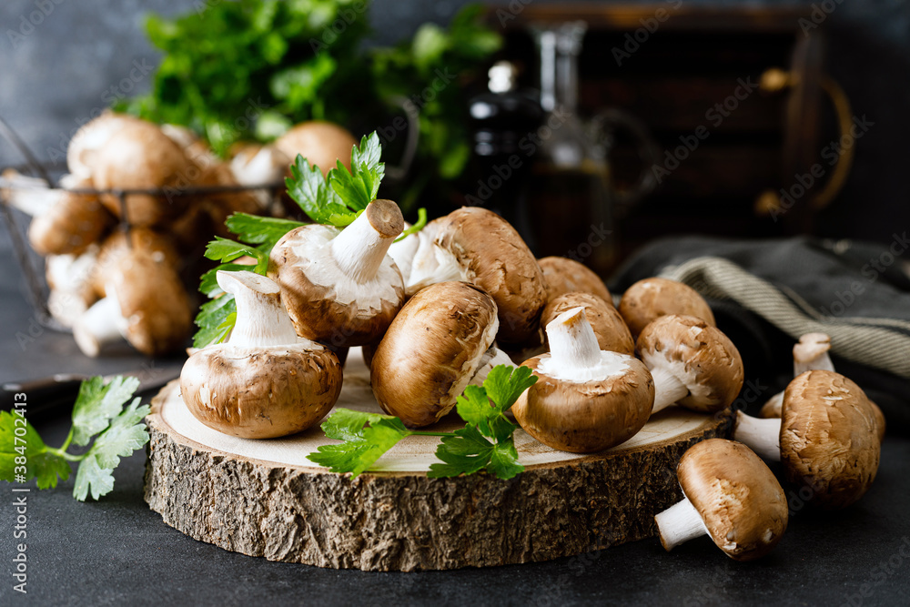 Sticker raw mushrooms champignons on black background, cooking fresh champignons.