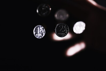 Volatility of the national currency. Russian coins with the inscription "ruble". Low ruble exchange rate. Fall of course. Financial crisis. Ruble in the hand.