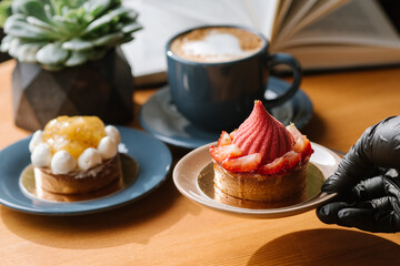 Sweet strawberry cupcake on the wooden table