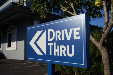 The drive thru sign outside a drive-through fast food restaurant.