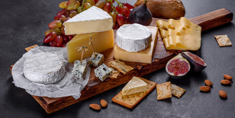Beautiful delicious camembert cheese, parmesan, brie with grapes and figs