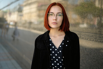 Portrait of beautiful redhead woman wearing glasses.