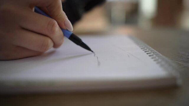 Girl, architect student cafe, sits, sketches, draws sketch, apartment plan white paper, an album, whatman paper mechanical pencil. Apartment, house renovation design project. Furniture placement plan.