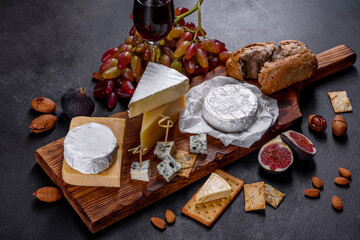 Beautiful delicious camembert cheese, parmesan, brie with grapes and figs