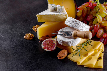 Beautiful delicious camembert cheese, parmesan, brie with grapes and figs