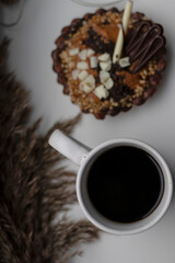 chocolate tartlet decorated with white chocolate crumbs