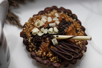 chocolate tartlet decorated with white chocolate crumbs