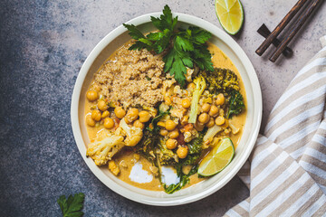 Vegan chickpea curry with cauliflower, broccoli, kale and quinoa, top view. Healthy vegetarian food...