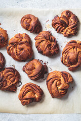 Traditional Swedish buns with cardamom and cinnamon, light background, top view. Scandinavian cuisine concept.