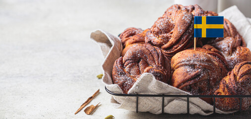 Traditional Swedish buns with cardamom and cinnamon, light background. Scandinavian cuisine concept.