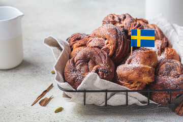 Traditional Swedish buns with cardamom and cinnamon, light background. Scandinavian cuisine concept.