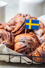 Traditional Swedish buns with cardamom and cinnamon, light background. Scandinavian cuisine concept.