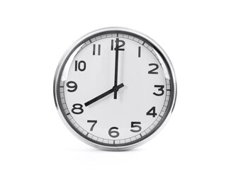 Silver shiny clock hanging on the wall with copy space