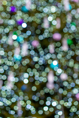 Abstract green bokeh background. Defocused abstract green background. Blurred holiday bokeh. vertical photo
