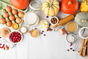 Ingredients for autumn winter baking - flour, sugar, eggs, apples, pumpkins and spices.