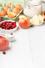 Ingredients for autumn winter baking - flour, sugar, eggs, apples, pumpkins and spices.