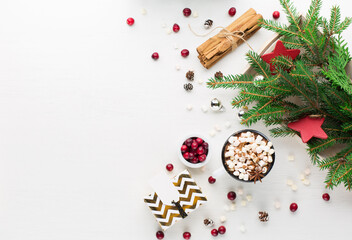 Obraz na płótnie Canvas Christmas decoration, cup of coffee, homemade sweet gingerbread cookies, pine cones and branches on white wooden background.