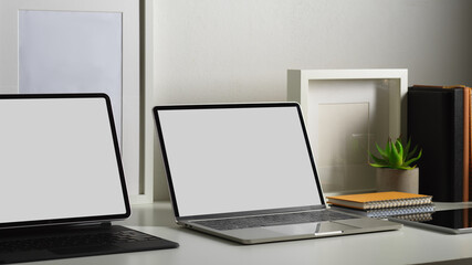 Fototapeta na wymiar Worktable with two laptop in crude clipping path in home office room