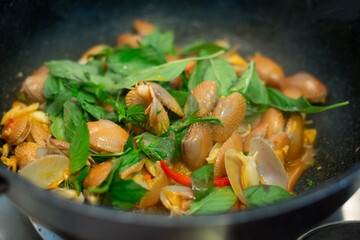stir fried spicy clams shell with basil leaves