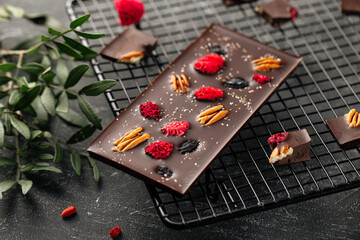 Handmade chocolate bar with pecan and dried berry