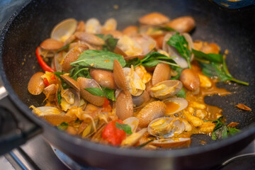 stir fried spicy clams shell with basil leaves