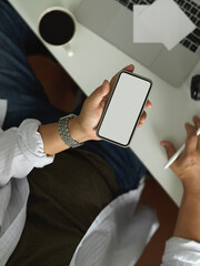 Male office worker using smartphone include clipping path on worktable