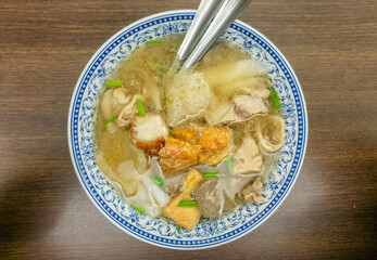 bowl of crispy belly pork with inside organ pork soup