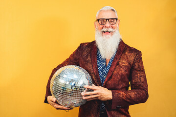 Senior fashion man celebrating new year's eve in disco club
