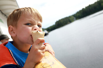 Child eating ice cream on ship