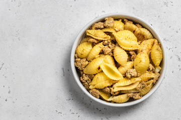 Delicious pasta shells minced meat. Space for text, top view.
