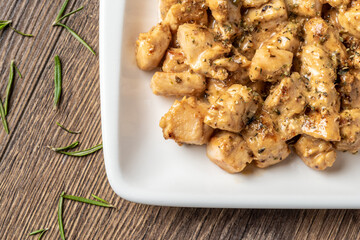 grilled cubed spicy chicken on wooden table