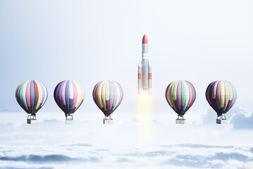 Fototapeta na wymiar Flying air balloons and rocket on blue sky background