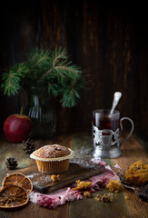 
Cupcakes and glass with tea on a wooden table