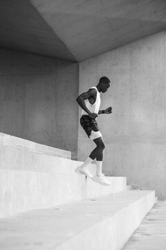 Side View Of Young Man Exercising On Steps Outside Building